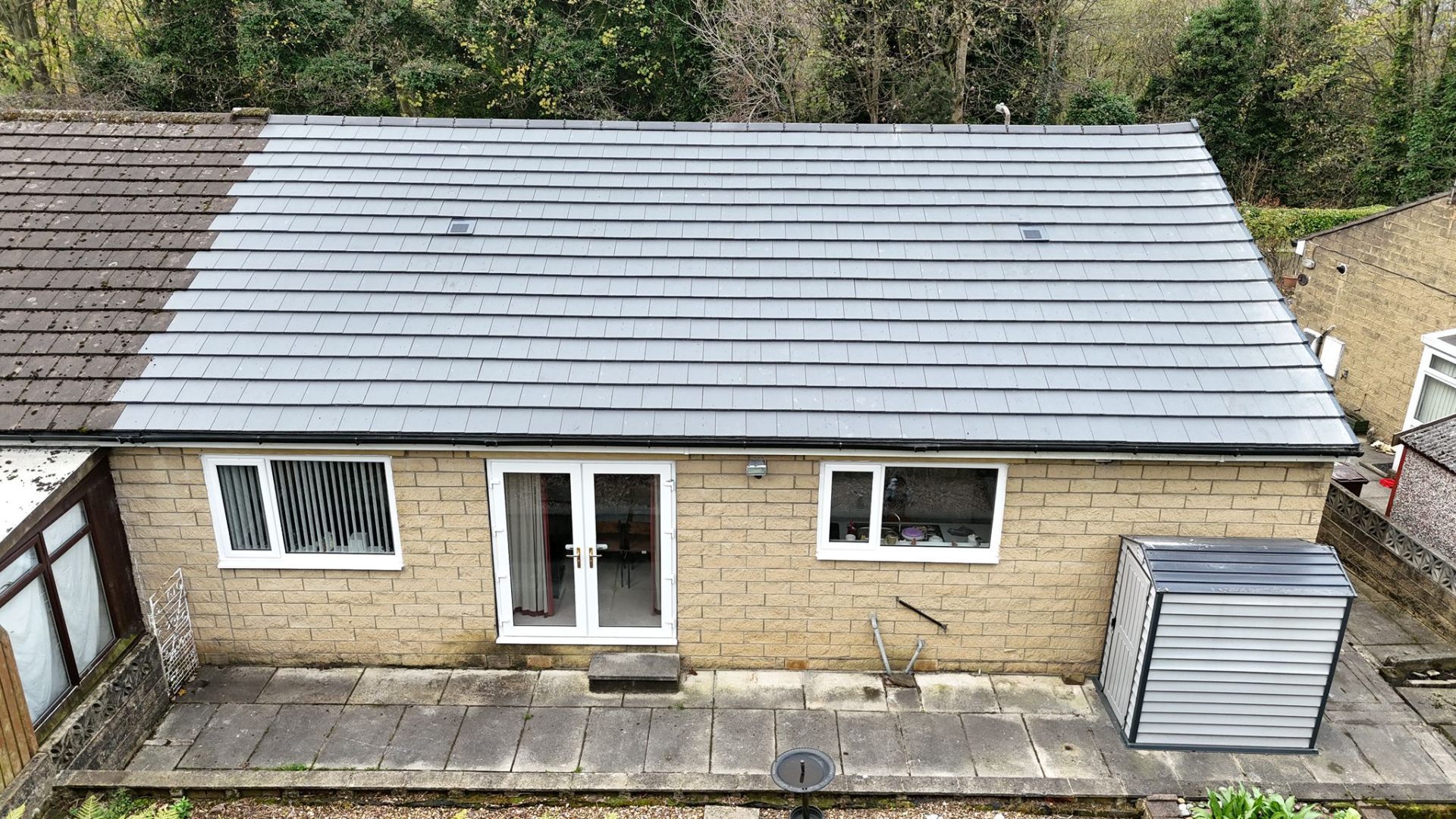 Rear view of bungalow re-roof showing new tile installation