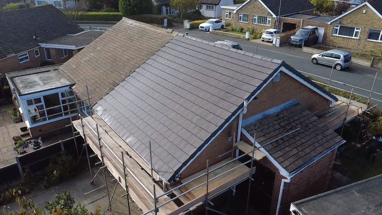 Completed new roof on a bungalow with scaffolding in Leeds