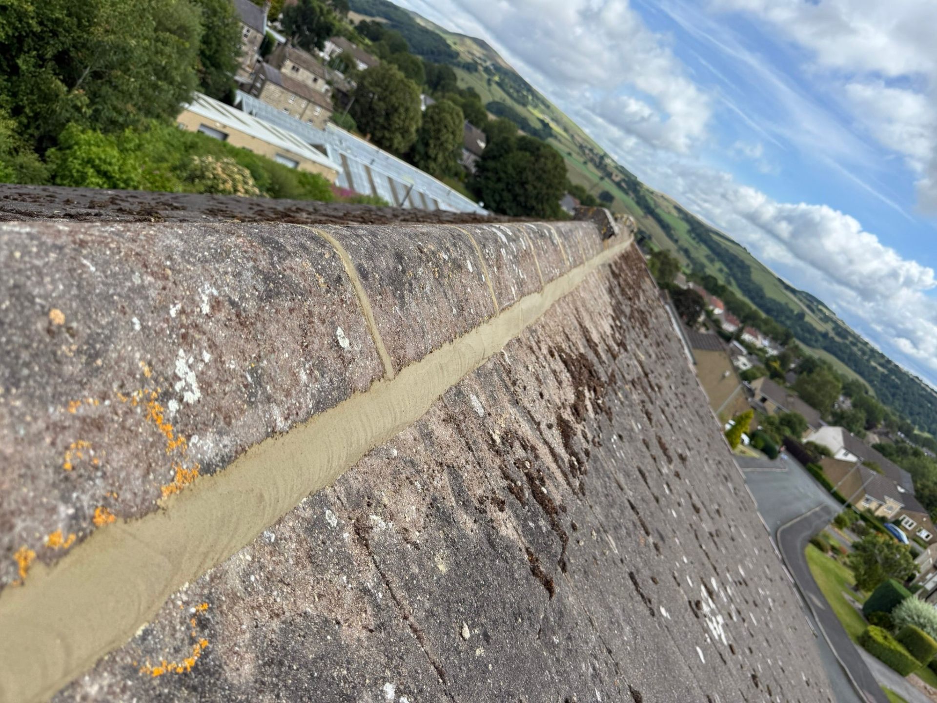 Ridge and valley tile repointing in progress