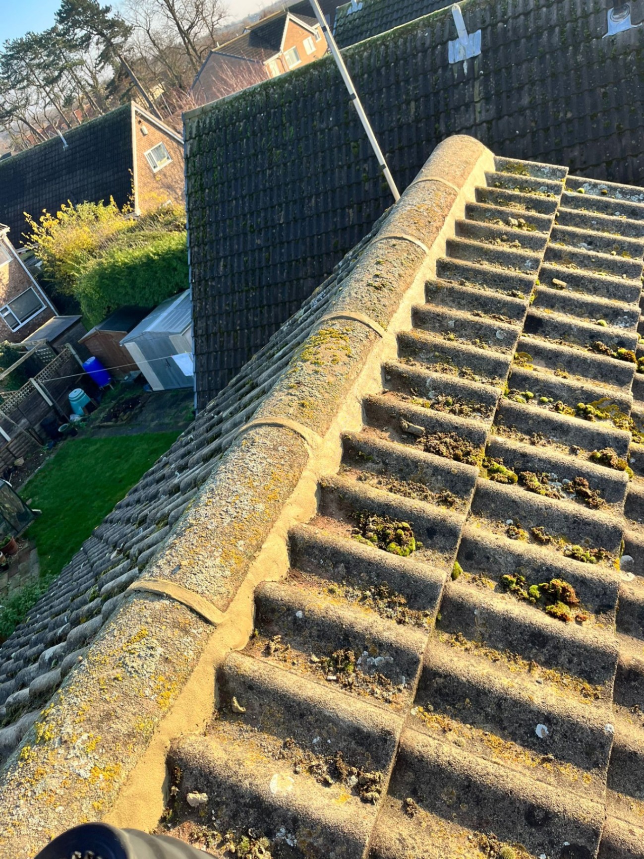 Roof ridge tiles before repointing by Arla Roofing in Leeds